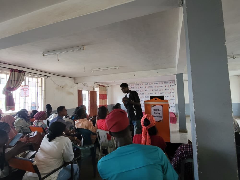 Muyiwa Adekojede answering a question from students in the main hall at Inspire Polytechnic
