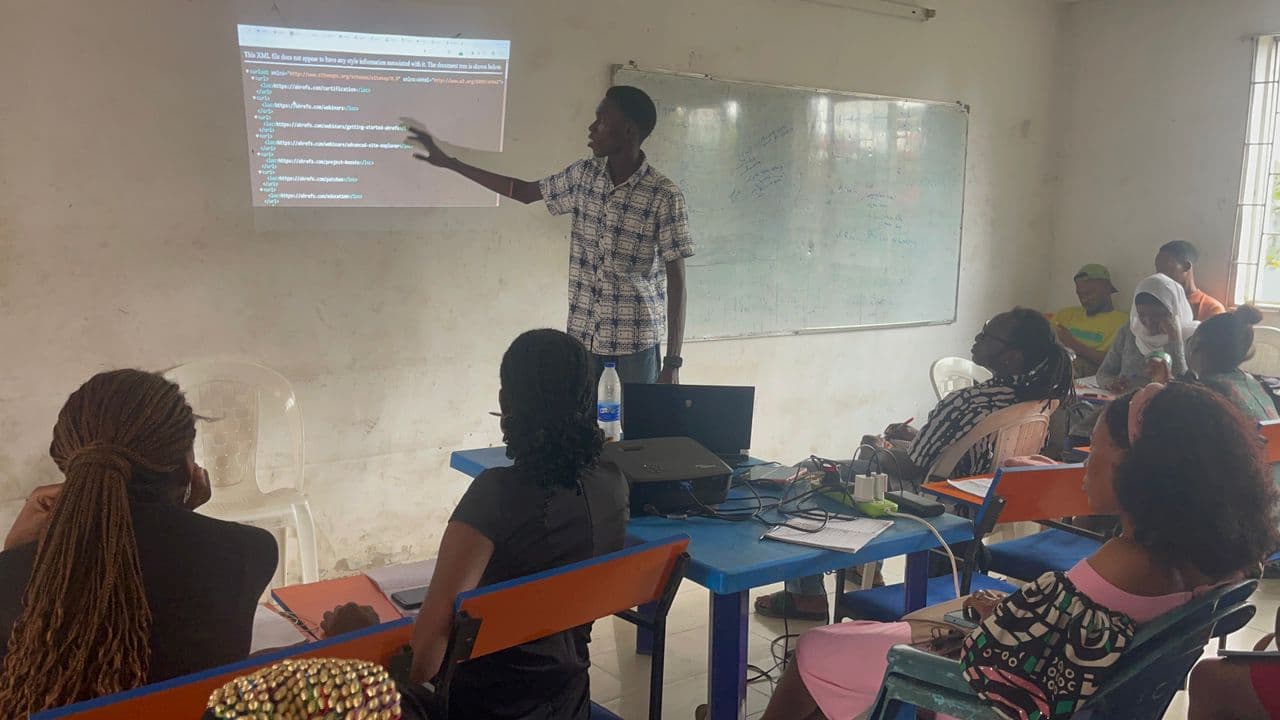 Muyiwa Adekojede pointing at a website's sitemap file projected on the classroom wall